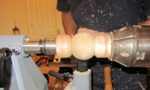 Removing the spigots by holding the ball between two cup chucks